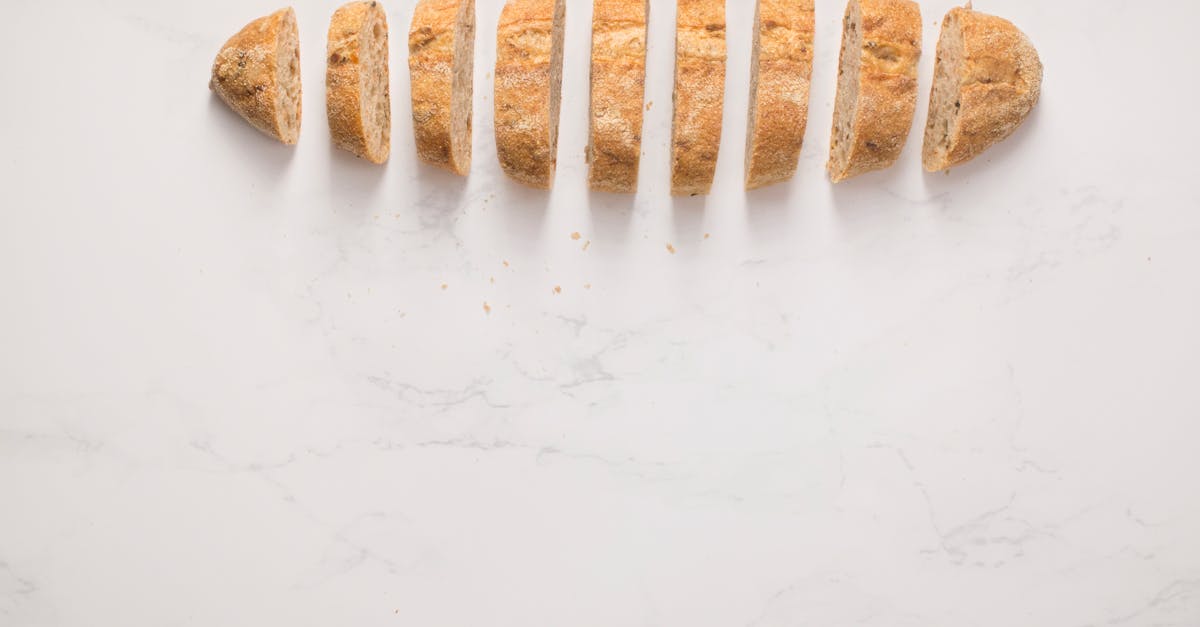 Top view of sliced homemade artisan bread on a marble surface, ideal for food photography.